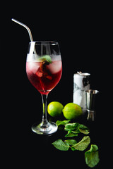 Gin tonic cocktail summer drink alcoholic with lime on bar black background