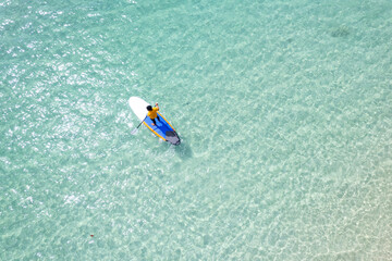 Aerial view of a kayak in the blue sea .Woman kayaking She does water sports activities.