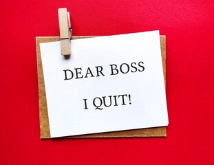 Card clip with envelope on red background with text words DEAR BOSS I QUIT, means to make decision to resign from full time work, employee quit their job to find work life balance, toxic workplace