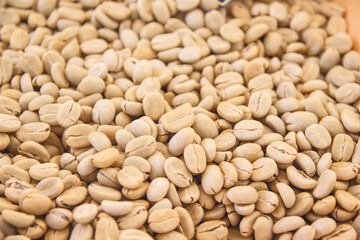 Close up raw coffee beans pile  background