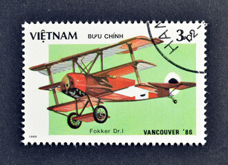 Cancelled postage stamp printed by Vietnam, that shows Fokker Dr-1 triplane, 
“EXPO'86” World...
