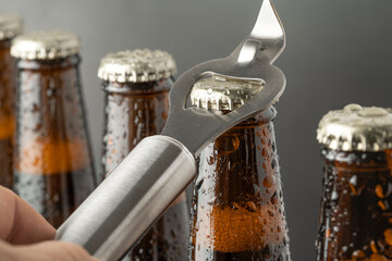 Cold beer in a brown bottle with large water drops on the glass surface. Dark craft beer