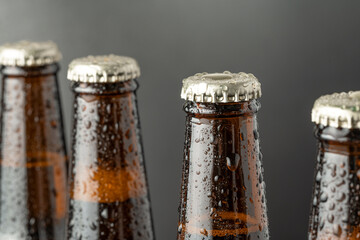 Cold beer in a brown bottle with large water drops on the glass surface. Dark craft beer
