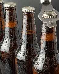 Cold beer in a brown bottle with large water drops on the glass surface. Dark craft beer
