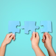 Business persons hands holding puzzle pieces
