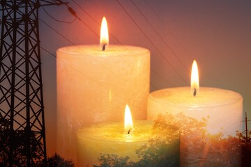 Burning flame of big candle on the power lines background.