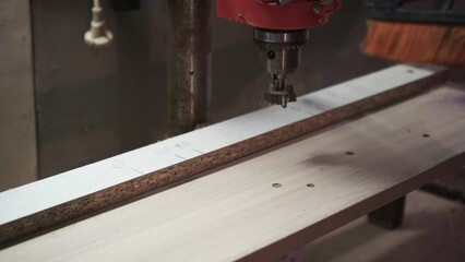 Unknown man cleaning wooden surface in carpentry workshop. Unrecognized handyman sweeping table in studio. Carpenter exempting from sawdust indoors in slow motion. - Powered by Adobe