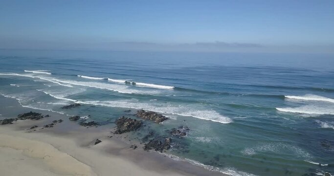 some surfers enjoying the perfect waves on the beach at Praia da arda, afife, Viana do Castelo.