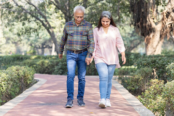 Fototapeta premium Happy senior couple spending leisure time in park during weekend