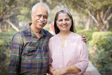Happy senior couple spending leisure time in park during weekend.