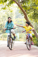 Family on a bike ride together outdoors on a sunny day.