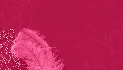 Ostrich feathers on background in shades of magenta with sparkles. Mardi Gras concept or New Years...