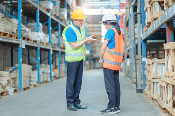 Warehouse worker being scolded and admonished by the supervisor ,Warehouse worker checking packages on shelf in a large store.