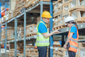 Warehouse worker being scolded and admonished by the supervisor ,Warehouse worker checking packages on shelf in a large store.