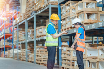 Warehouse worker being scolded and admonished by the supervisor ,Warehouse worker checking packages on shelf in a large store.