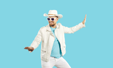 Happy funny confident attractive young man wearing white leather jacket, white cowboy hat and...