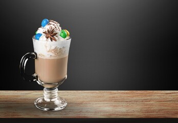 Tasty sweet latte coffee with cream in cup