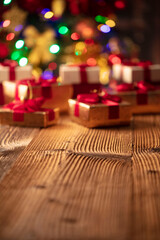 Christmas background. Shallow depth of focus. Colorful bokeh lights, rustic wooden table. Place for typography. 