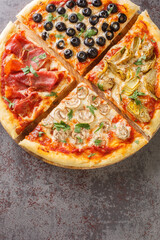 four seasons pizza quattro stagioni made with tomato sauce, mozzarella cheese, ham, artichokes,...