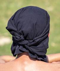 Black bandana on the man's head.
