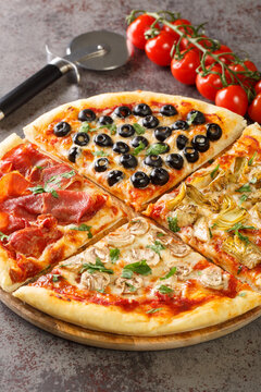 Italian pizza four seasons or quattro stagioni include combination of tomatoes, mozzarella, mushrooms, artichokes, ham, and olives closeup on the table. Vertical