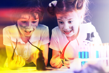 Background with highlights of children of scientists. A boy and a girl are experimenting in the laboratory.