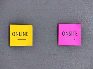 Yellow and pink stick note on wall with direction to ONLINE and ONSITE, education and work choices in pandemic, digital revolution turned conventional working and studying onsite to online or hybrid  - obrazy, fototapety, plakaty