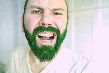 Happy saint patricks day. A man with a green beard. St.Patrick 's Day. Irish fan color beard.