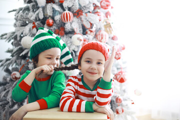 Santa Claus sitting with little cute elves over Christmas background. Time of miracles. Gifts from Santa Claus.