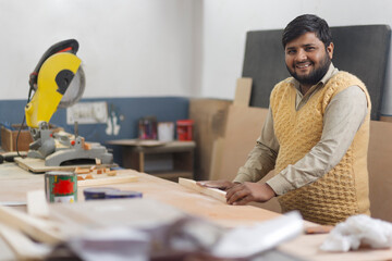 Young carpenter in his work shop