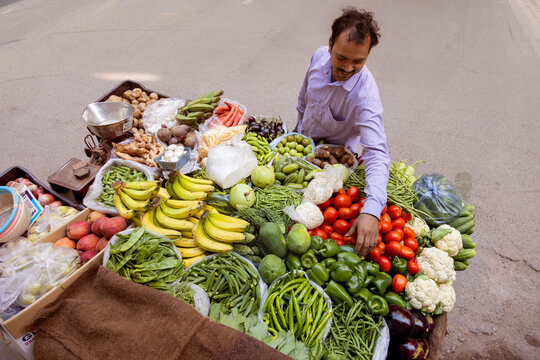 Male vendor selling vegetables at his roadside stall
