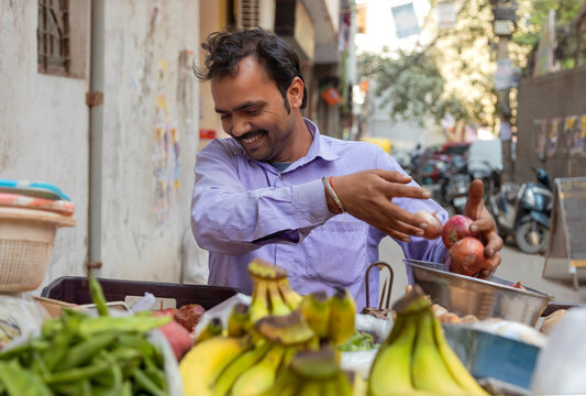 Male vendor selling vegetables at his roadside stall