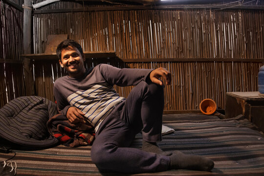Rickshaw puller resting  in his hut
