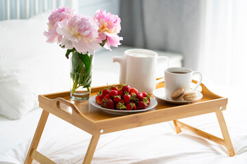 Tray with breakfast on bed.	

