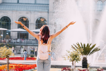 Happy tourist girl walks and enjoys holiday in the Botanical Flora garden in Cologne, Germany....