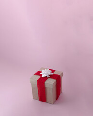 A gift wrapped with red ribbon and white bow