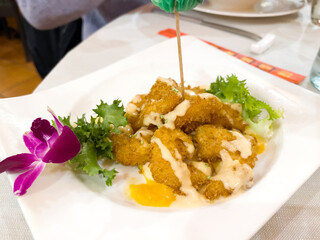 Crispy breaded prawns plate with mayonaisse and lettuce. Hot appetizer concept