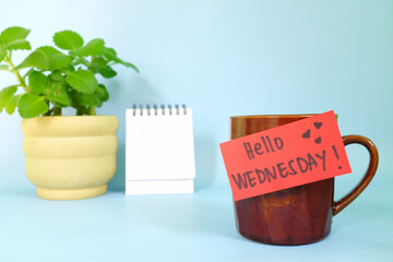 Welcome, hello and happy Wednesday concept. Selective focus of coffee cup with red paper note and...