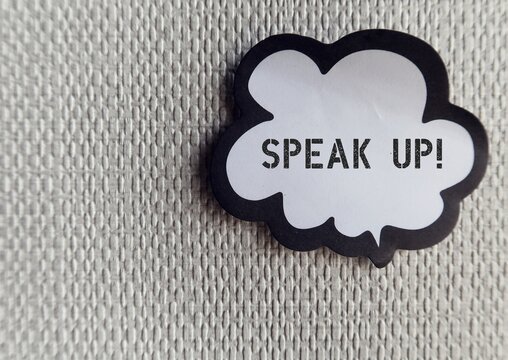 Word ballon on wallpaper with text SPEAK UP , self reminder to raise voice louder or dare to express opinion frankly and openly , stand up for yourself