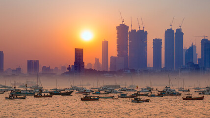Air pollution concept - Modern highrise rich buildings and poor slums at sunset - Mumbai, india 