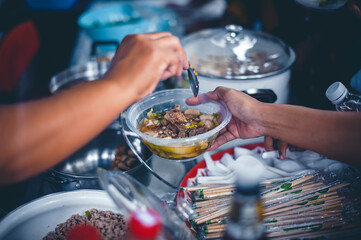 Volunteers come to donate food to hungry people : the concept of sharing