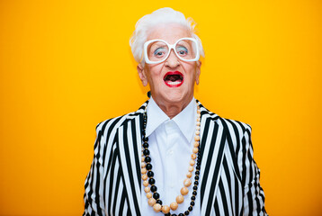 Funny grandmother portraits. Senior old woman dressing elegant for a special event. granny fashion...