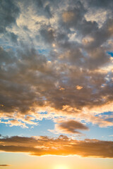 Vertical Abstract nature background. Dramatic and moody yellow, purple and blue cloudy sunset sky