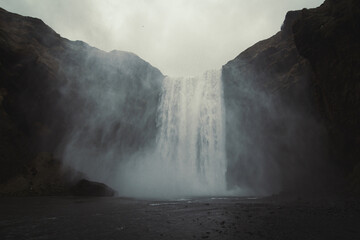 Skogafoss waterfall landscape photo. Iceland nature. Beautiful nature scenery photography with grey...