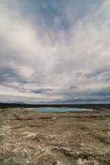 Great geysir between eruptions landscape photo. Beautiful nature scenery photography with cloudy sky on background. Idyllic scene. High quality picture for wallpaper, travel blog, magazine, article