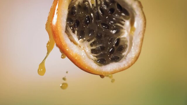 Slow Motion Macro Shot of Flowing Granadilla Juice from Halved Granadilla