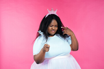 Image of a beautiful woman posing in a fairy costume on a pink background - obrazy, fototapety, plakaty