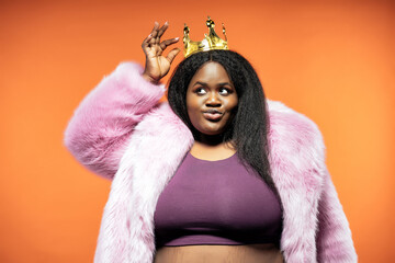 Image of a beautiful woman posing in a furry coat on a colored background