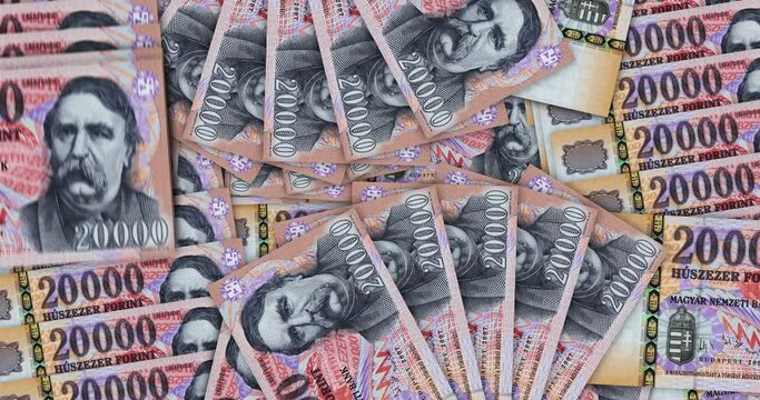 Hungarian Forint banknotes in a cash fan mosaic pattern loop. Hungary 20000 HUF notes. Abstract concept of bank, finance, economy seamless and looped decorative design background.