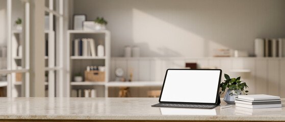 Workspace with tablet mockup and copy space over blurred background of minimal working room